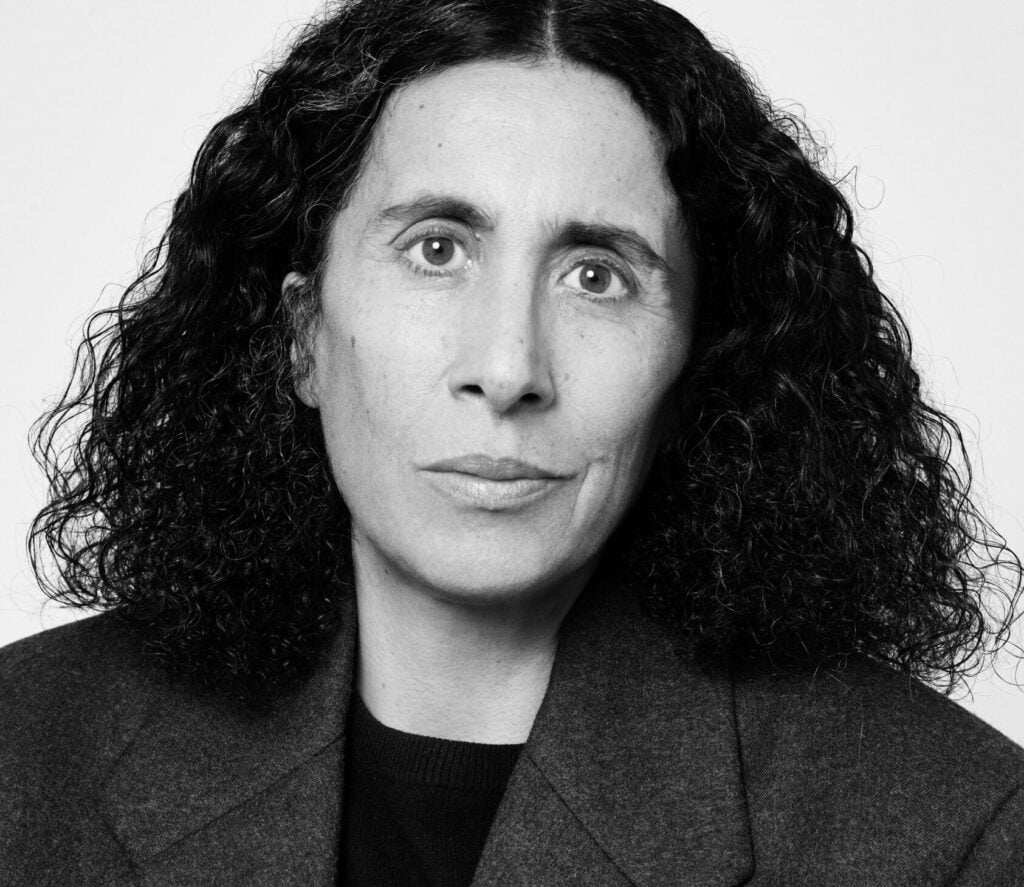 Black-and-white portrait of Sara Sozzani Maino wearing a dark tailored jacket.
