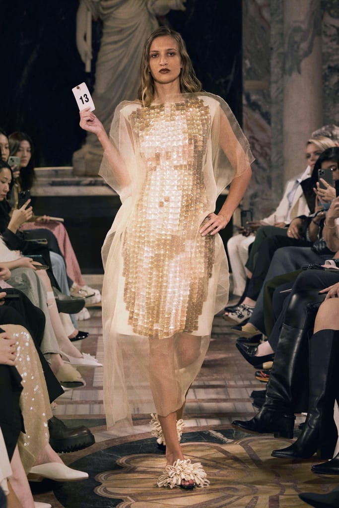 Runway look from Zhong Zixin SS25 “Bacchus” featuring grape motifs and Art Deco-inspired sculptural silhouette