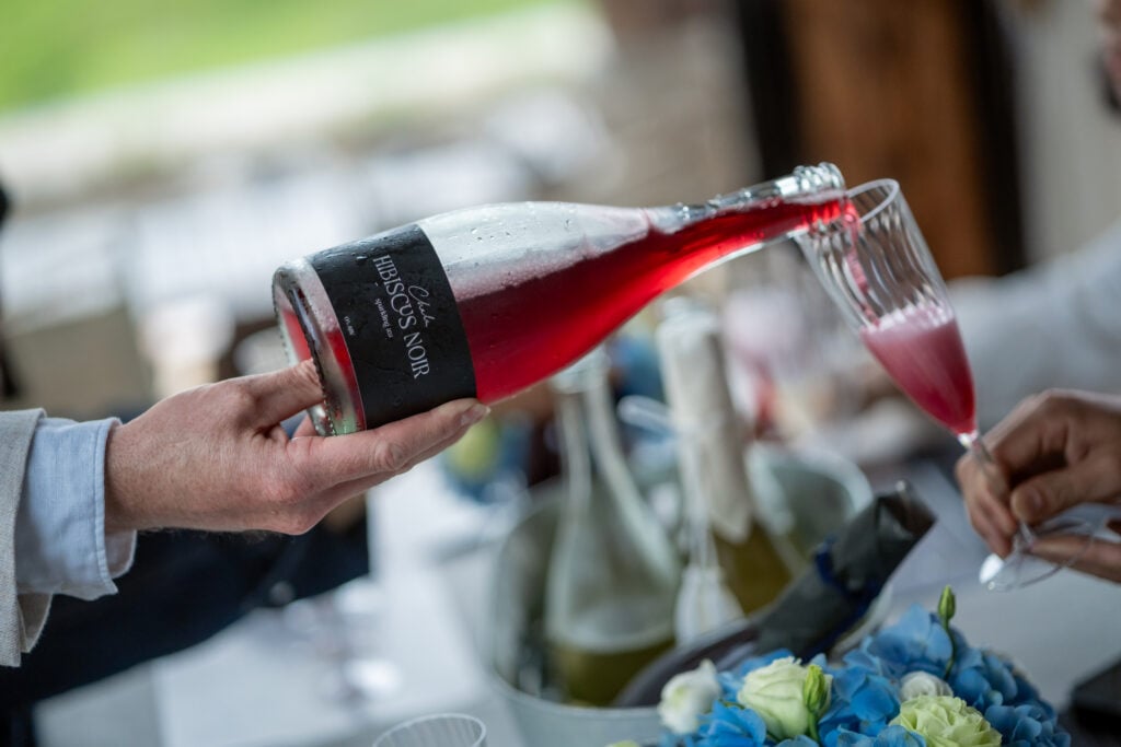 Chalu Hibiscus Noir sparkling tea, a cuvée blend of hibiscus, wild camellia, strawberry, and raspberry inspired by Pinot Noir flavor notes.